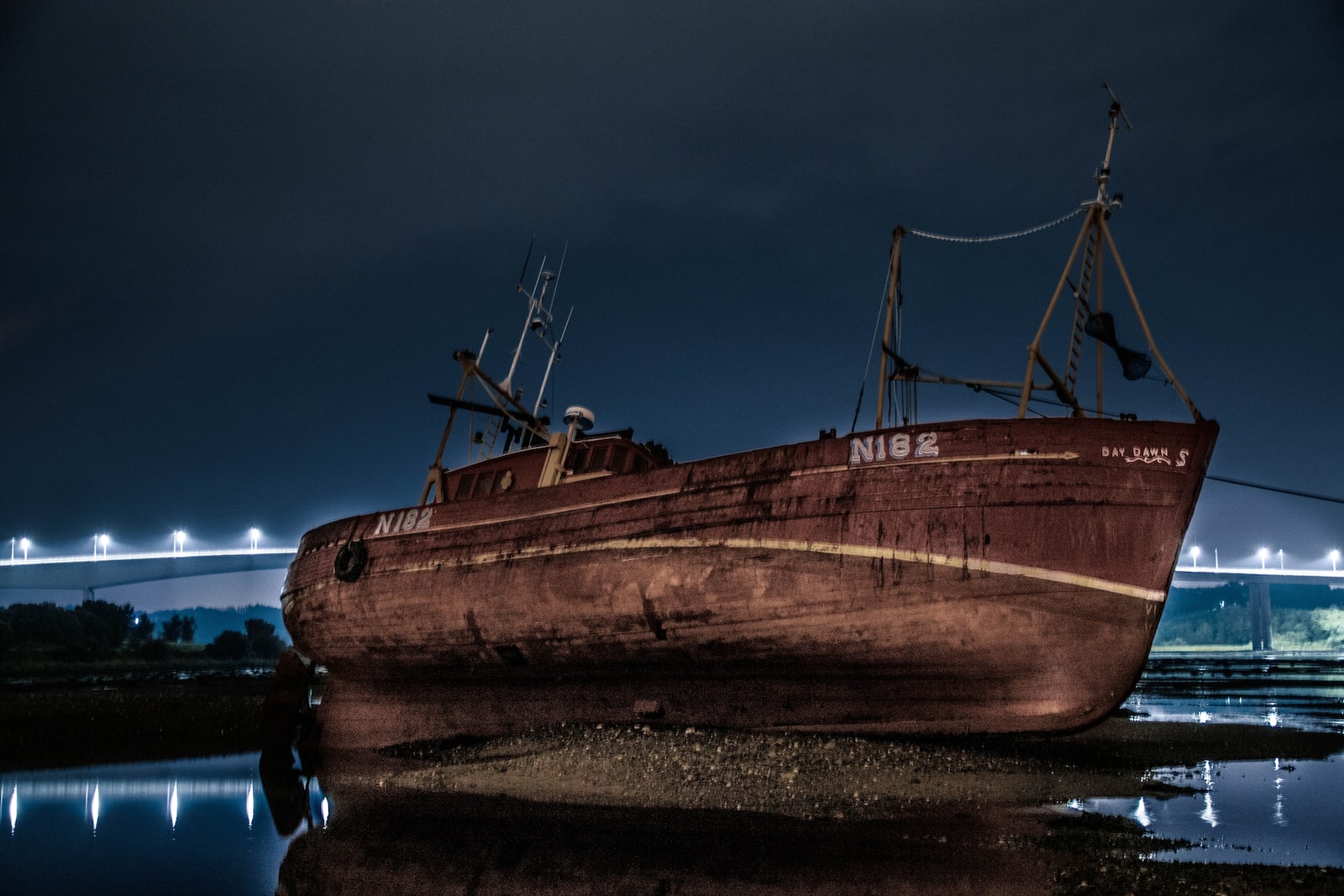 brown wooden boat on brown sand during night time