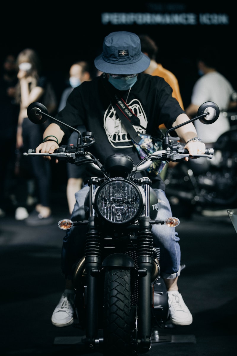 man in black and white jacket riding black motorcycle