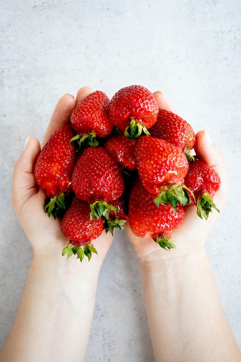 strawberries on persons hand