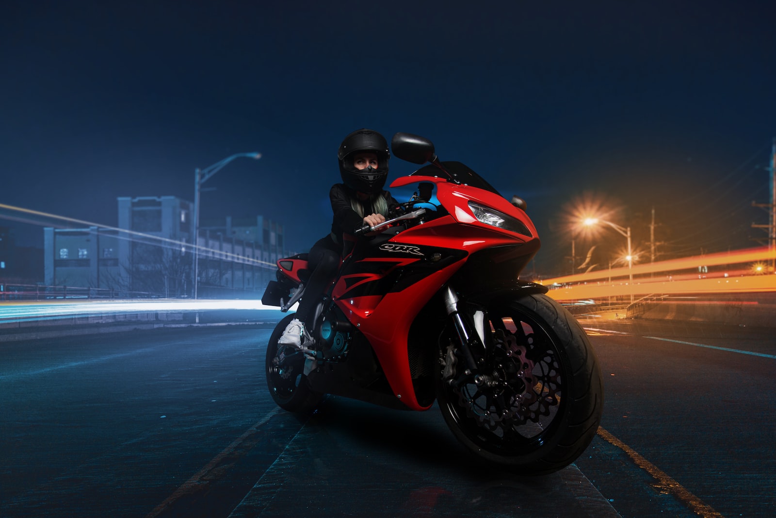 red and black sports bike on road during nighttime